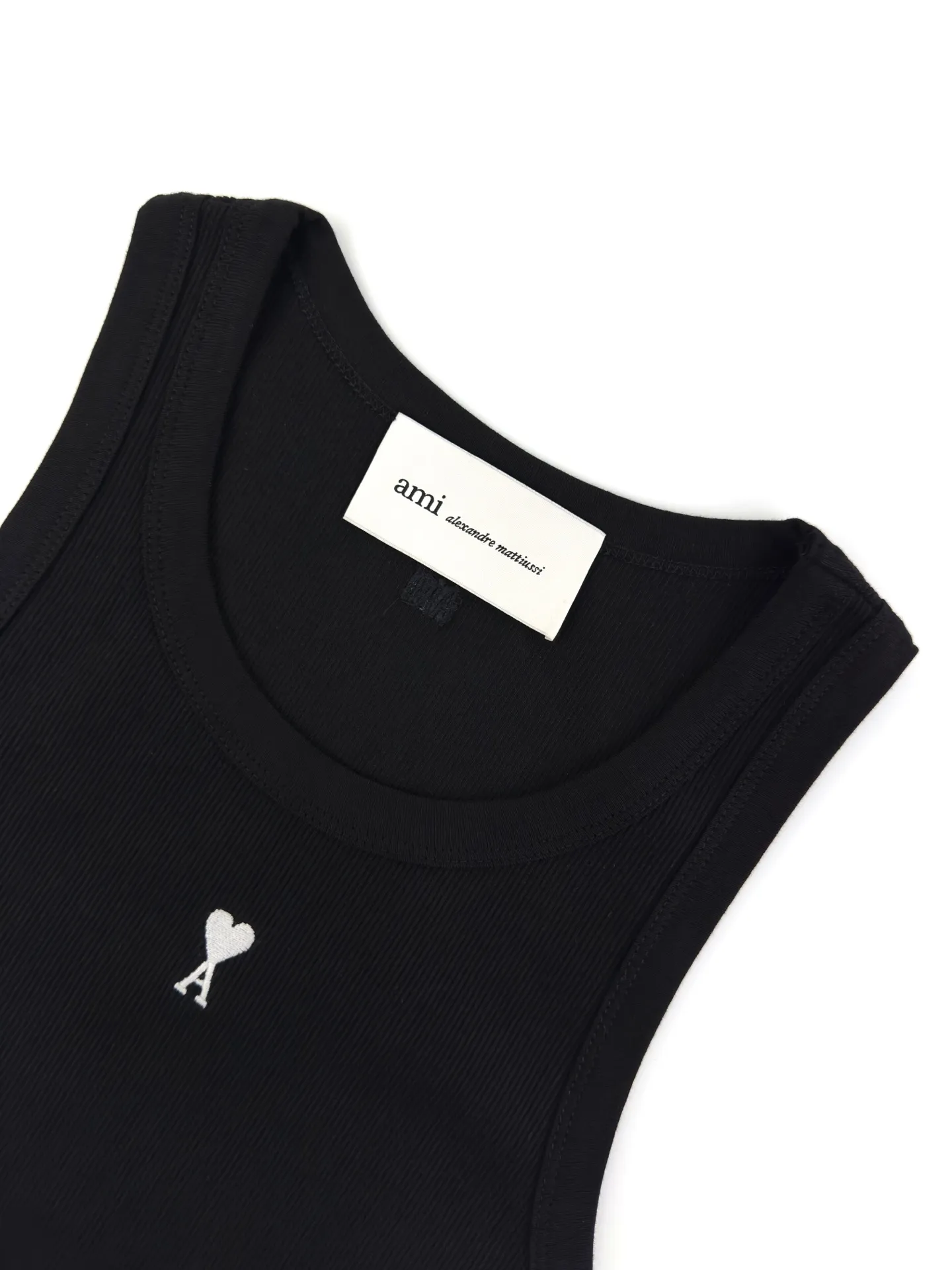 Logo embroidered vest Customized luxurious and soft plain cotton, cloudy and skin-friendly, clean and refreshing Breathable, simple black tones embody French sophistication, showing a luxurious style when relaxed. Love logo lightly embroidered on the front, Ami embroidery on the back neck with dark engraved texture, French attitude on both sides, minimalist and quality, interior with hidden charm, easy to wear alone, Versatile is elegant and effortless. Process 1: Using imported machine embroidery technology Use advanced computer control systems and precision mechanical components to achieve Ami logo and letter embroidery operations with high precision and smooth and delicate lines. Process 2: The fabrics have been fermented and washed for a better hand feel. Not easy to deform, not easy to shrink, not easy to fade, and maintain long-term beauty. Accessories: Customized 1:1 Ami trademark. Version: Fitted version. Size: S M L XL. Style number: AA 603.